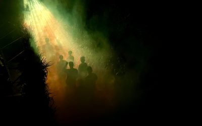 People walking through the maze in the dark during Corn Maze Nights at Pienland Farms.
