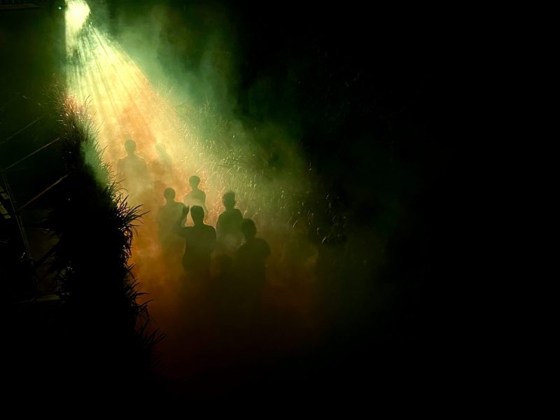 People walking through the maze in the dark during Corn Maze Nights.