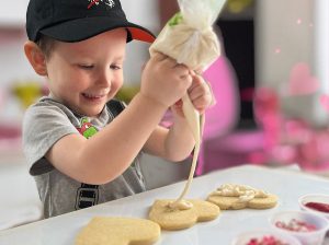 Kid decorating cookies