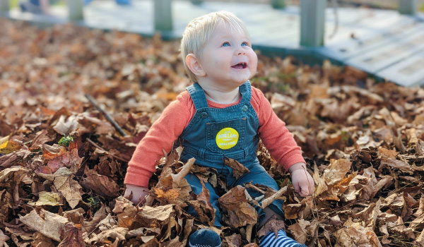 kid in leaves