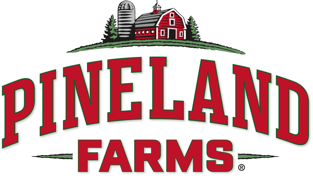 Pineland Farms red and green logo with illustrated red block letters and bard with silo.